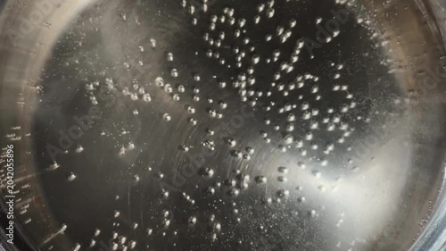 Water in stainless steel pot during the boiling close-up