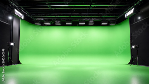 A modern green screen studio with professional lighting setups, ideal for video production and creative projects.