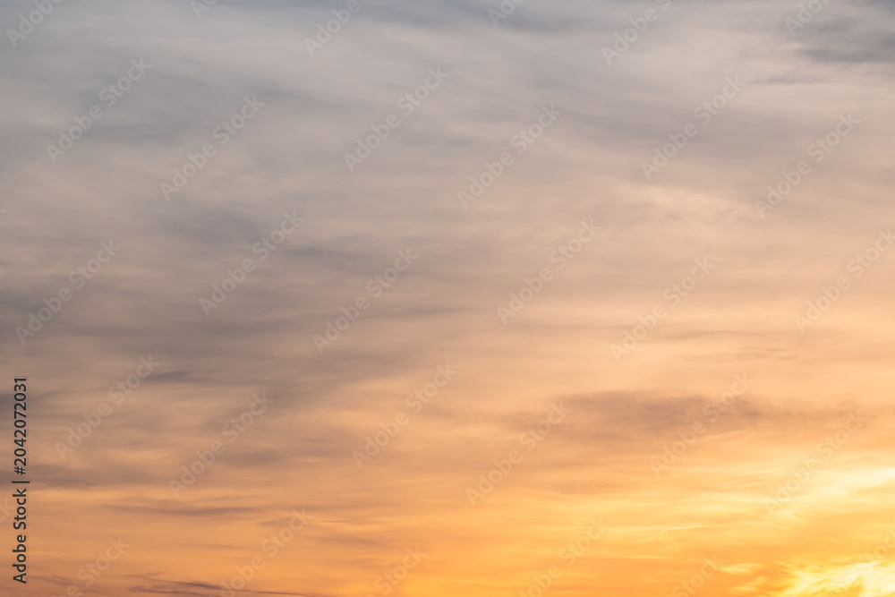 Fototapeta premium Sky sunset,Beautiful sunrise sky with vibrant gradient orange and gold colors and soft blue, Clear atmosphere with wispy clouds. Peaceful, perfect for background and copy space, High resolution images