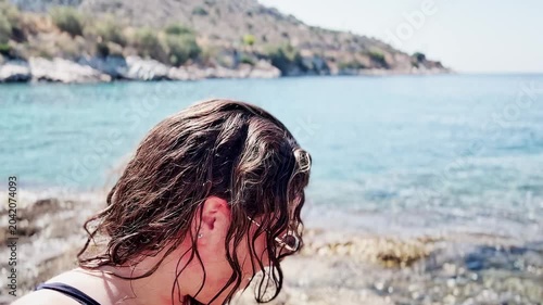 Smiling Woman in Swimsuit and Sunglasses Enjoying Sunny Beach.