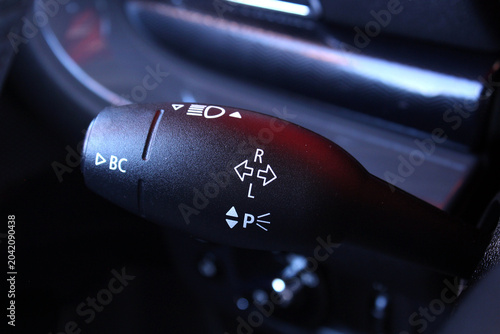 Photos Black multifunction stalk control featuring headlight turn signal and parking light symbols with chrome details