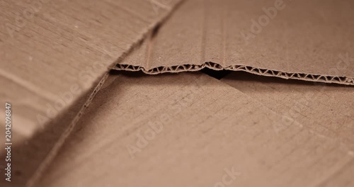 old crumpled cardboard folded for storage, used old cardboard from recycled paper is stored after using it as packaging material, cardboard box