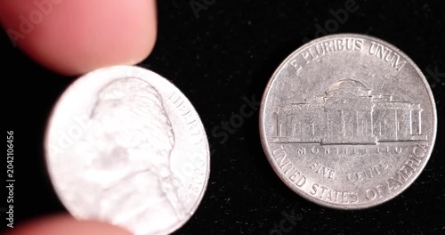 An old  worn five-cent coin on a black background, one old, worn, scratched 5-cent coin in close-up on black velvet, close up