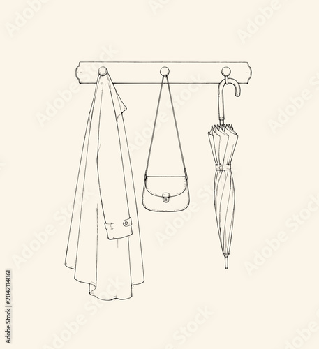 Photos A stylish arrangement of essentials for every rainy day: a chic coat, a compact handbag, and a trusty umbrella