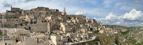Quadro su tela Historic stone hillside town Matera under dramatic cloudy sky, Basilicata, Italy