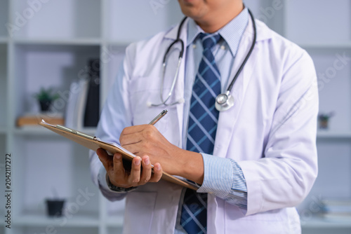 Φωτογραφία Doctor taking notes in a clinic medical office environment close-up shot healthc