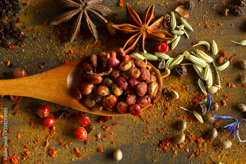 Spices and seasoning in a spoon on a black background