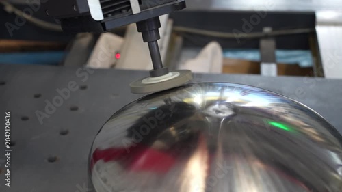 robotic arm handling the metal machined shaft parts polishing between the production line. automotive parts manufacturing process. 