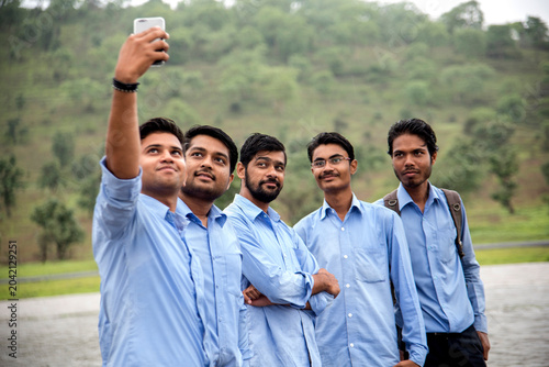 Bild auf Leinwand Young Indian People taking a selfie with Smartphone at outdoors.