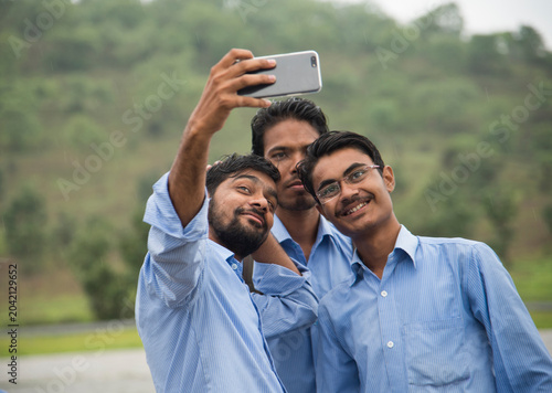 Bild auf Leinwand Young Indian People taking a selfie with Smartphone at outdoors.