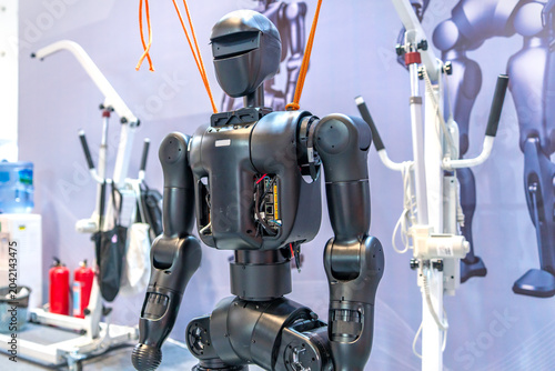 Humanoid Robot with Orange Cables in Tech Exhibition