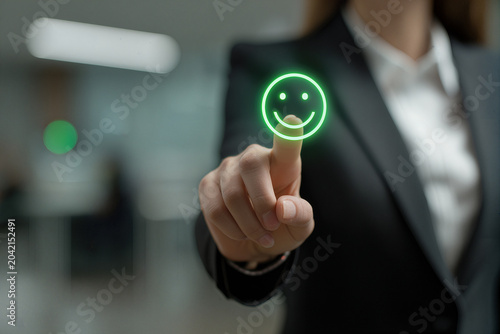Happy Workspace Businesswoman Engages with Interactive Smiley Icon in Modern Office