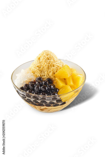 Traditional Taiwanese pineapple shaved snow ice topped with sweet pineapple compote, pearls, and coconut jelly, isolated.