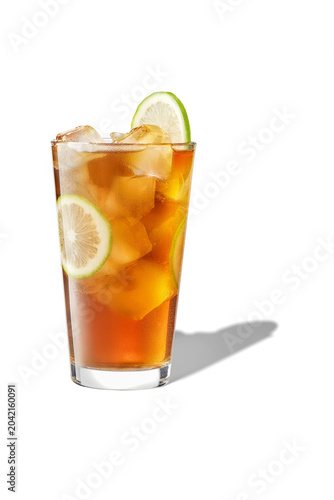 Eye level shot of refreshing iced herbal tea drink with fresh lime slices and ice cubes, isolated.