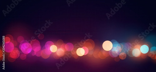 Bokeh lights create a colorful atmosphere during a nighttime event in the city