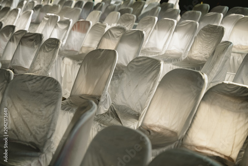 Rows of neat, patterned white chairs covered in clean cloth
