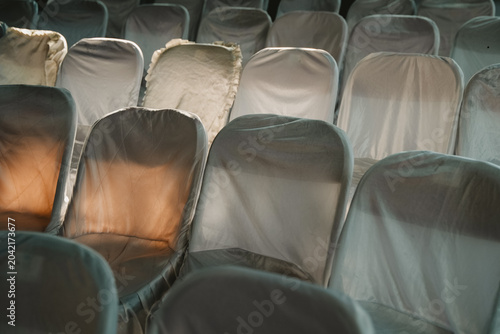 Rows of neat, patterned white chairs covered in clean cloth