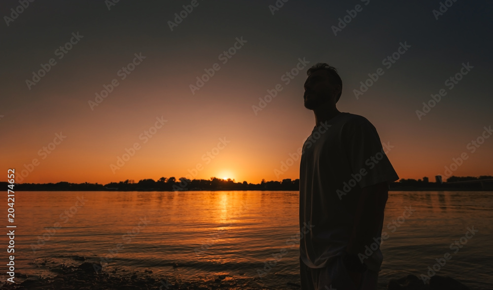 Fototapeta premium Silhouette Man Watching Peaceful Sunset Horizon