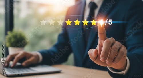 Businessman giving a four out of five star rating on a digital interface