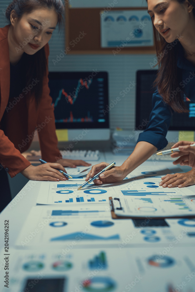 Fototapeta premium Business team collaborating on data analysis, reviewing financial reports and marketing statistics in a modern office meeting
