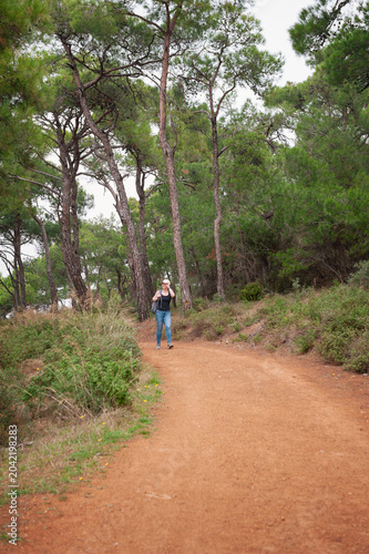 Hiker woman with backpack lifestyle exploring forest trail