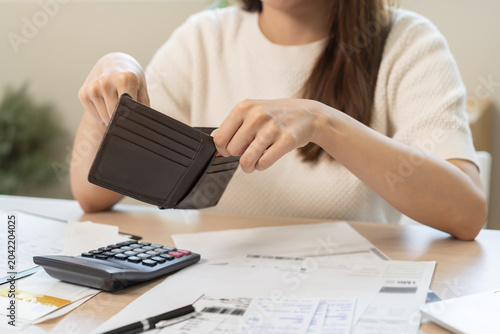Fotografie Debt financial concept, stressed problem asian woman hand open empty wallet, purse not have budget of money to pay no have credit card, not able payment bill, loan or expense with bank, bankruptcy