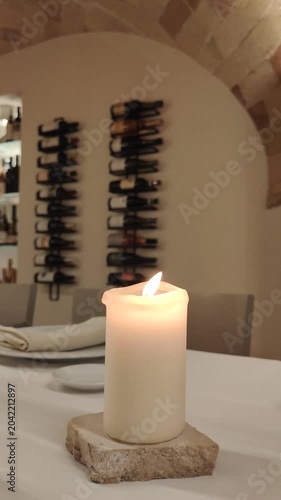 lit candle on a restaurant table