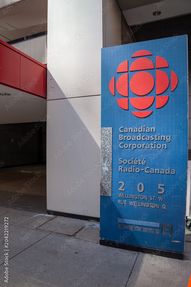 Fototapeta premium Toronto, Ontario, Canada - June 19, 2018: A signage for Canadian Broadcasting Corporation at one of the entrances to the headquarters on Wellington Street West in Toronto, Ontario, Canada. 