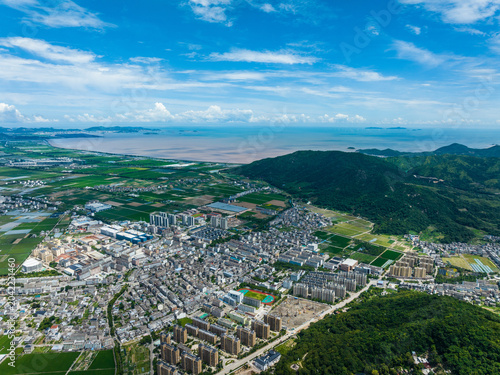 Aerial panorama of coastal town, farmland and bay in Wenling, Zhejiang, China