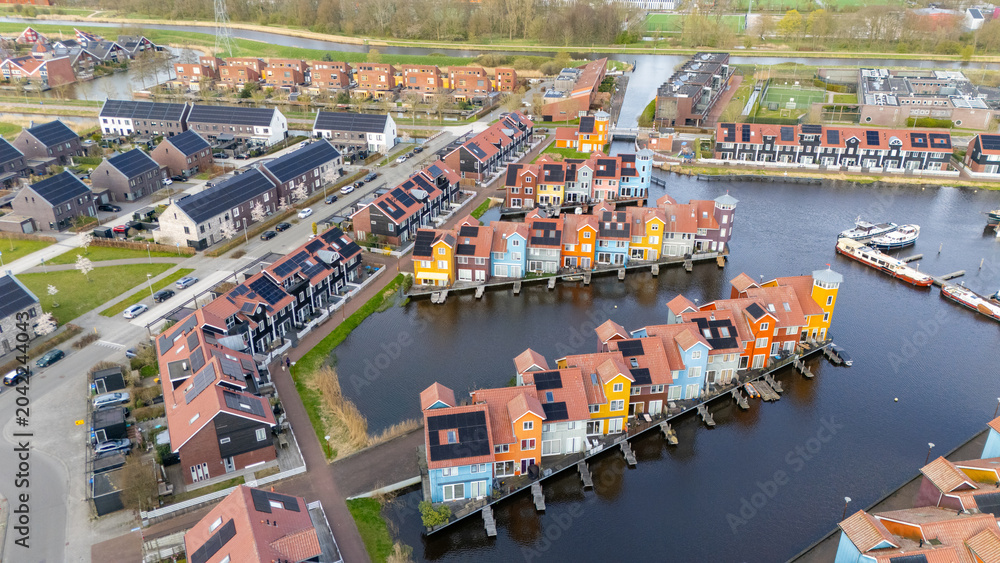 Fototapeta premium Drone aerial view of reitdiephaven groningen colorfull houses at the water