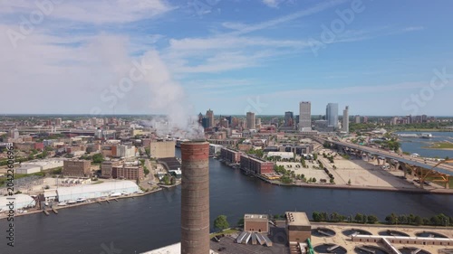 alt flying clockwise around smokestack revealing downtown Milwaukee
