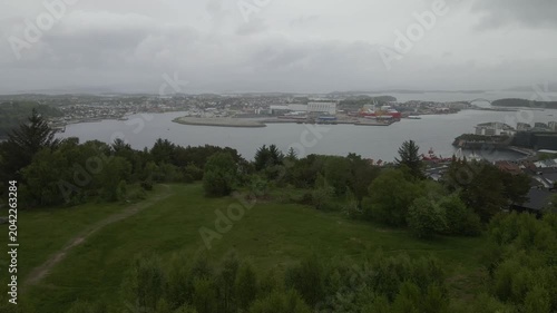 This high-quality aerial drone footage captures a quiet residential neighborhood on the outskirts of Stavanger, Norway. Filmed during the midday hours under a soft, overcast sky.