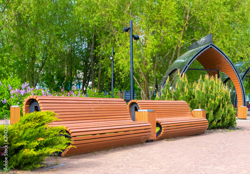 Modern wooden park benches. Landscape design.