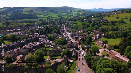 Aerial drone flyover shot of Hathersage village and main road in Peak District
