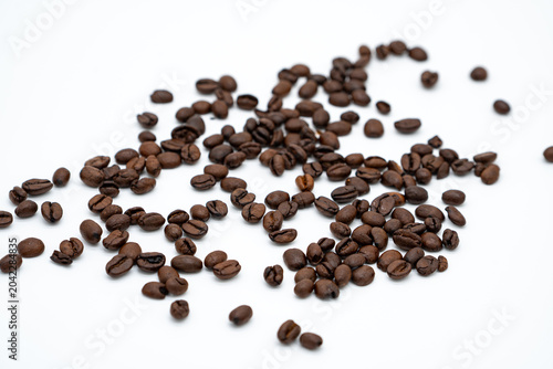 Konstfotografi Scattered Roasted Coffee Beans on White Background with Copy Space