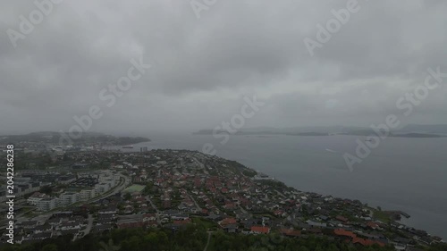 This high-quality aerial drone footage captures a quiet residential neighborhood on the outskirts of Stavanger, Norway. Filmed during the midday hours under a soft, overcast sky.