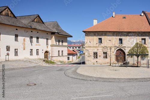 Historic renaissance burgher houses with colorful facades along a quiet empty street in the historic district of Spisska Sobota, Slovakia.