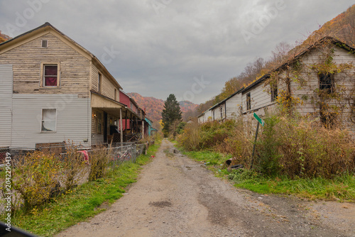 Weathered residential buildings along an unpaved roadway