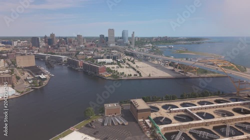 aerial view of downtown Milwaukee flying back past smokestack