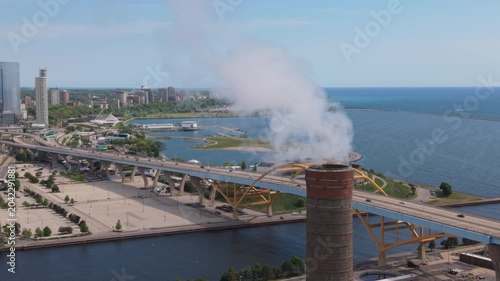 alt flying counter clockwise around smokestack revealing downtown Milwaukee