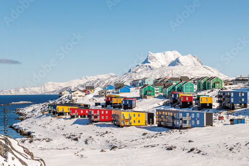 Arctic residential landscape with modern colorful Greenlandic houses, sea coast, winter snow and Sermitsiaq mountain, Nuuk, Sermersooq, Greenland