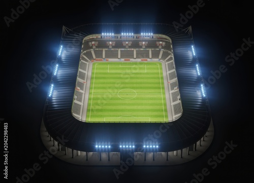 Top down aerial view of empty soccer stadium illuminated at night.