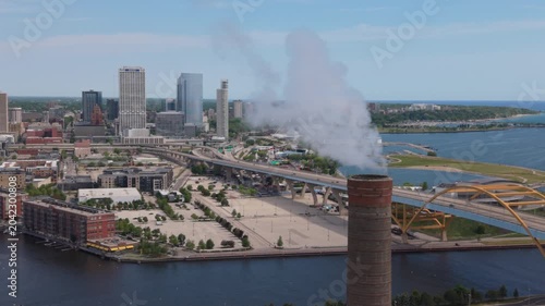 tighter flying past smokestack towards downtown Milwaukee