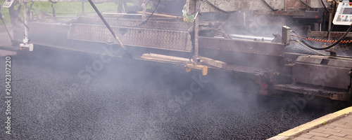 Fotografie Asphalt Paving Works in Urban Area During Road Construction Project