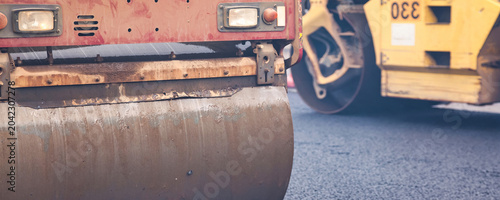 Schilderij op canvas Paving Asphalt on City Streets With Heavy Machinery in Urban Area During Daytime