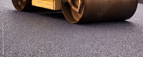 Schilderij op canvas Heavy Machinery Works on Asphalt Paving for Street Road Construction in an Urban