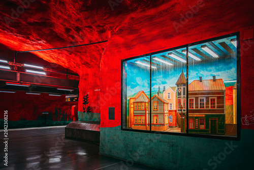 Tablou pe pânză Solna Centrum metro station with red walls and painted mural of houses, Stockhol