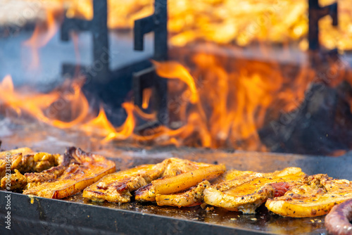 Tableau sur toile A captivating, close-up commercial shot of seasoned pork belly steaks sizzling on a hot flat-top grill surface