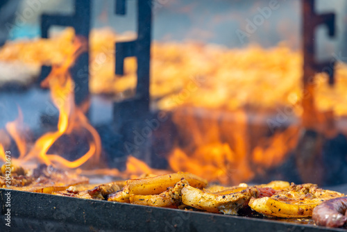 Photos A captivating, close-up commercial shot of seasoned pork belly steaks sizzling on a hot flat-top grill surface