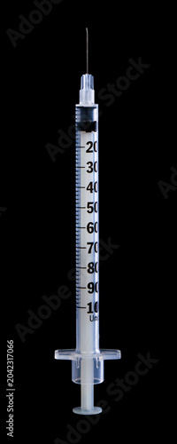 Syringe isolated on black background.